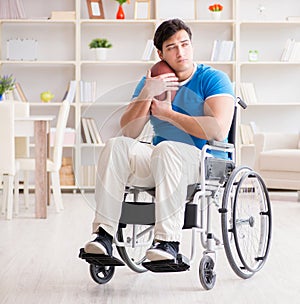 Young man american football player recovering on wheelchair