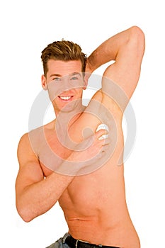 Young man applying deodorant