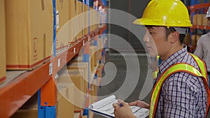 Young man applying shipping label to packaging and check document and manager talking in the warehouse.