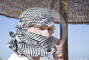 Young man with arab scarf in face