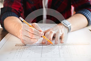 Young man architect working in the office ocuupation