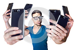 Influencer holding an exaggerated number of smartphones - isolated on white photo