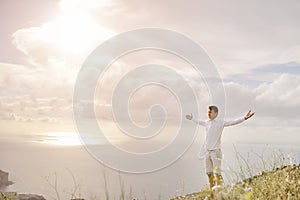 Young man with arms wide open - relax freedom success concept