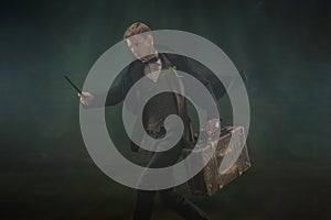 Young man in art action isolated on dark green background. Retro style, comparison of eras concept.