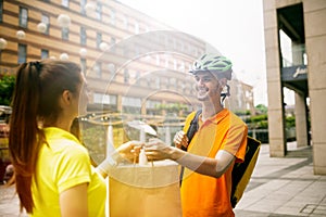 Young man as a courier delivering package using gadgets