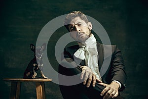 Young man as Dorian Gray on dark background. Retro style, comparison of eras concept.