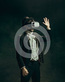 Young man as Dorian Gray on dark background. Retro style, comparison of eras concept.