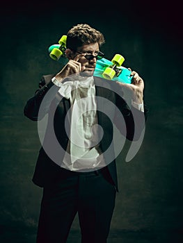 Young man as Dorian Gray on dark background. Retro style, comparison of eras concept.