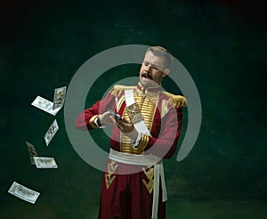 Young man as Nicholas II on dark green background. Retro style, comparison of eras concept.