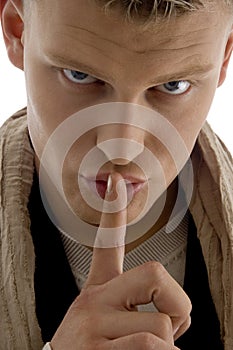 Young man asking to keep shushing