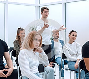 Young man asks a question at a business seminar