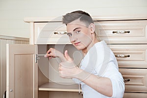 Young man assembling furniture