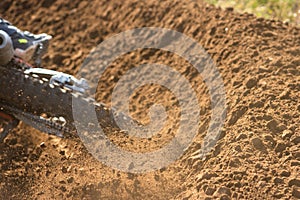 A young man, a man, an athlete, driving a motocross motorcycle in the blur, on a dirt track. Movement, blur, slow-motion