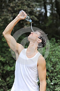 Young man athlete refresh himself