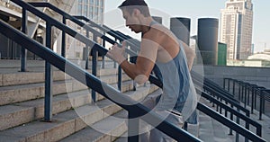 young man athlete running up stairs training intense cardio workout exercise male runner jogging on steps in urban city