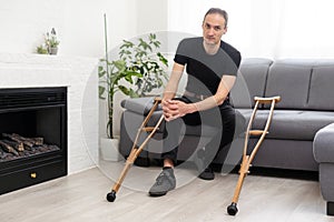 Young man with axillary crutches photo