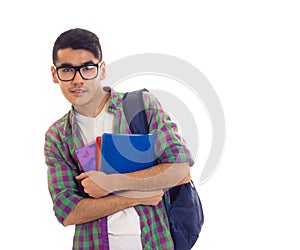 Young man with backpack and books