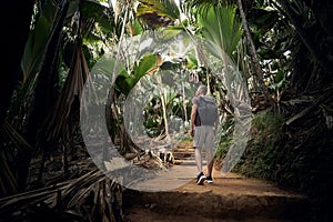 Young man with backpack discovering jungle