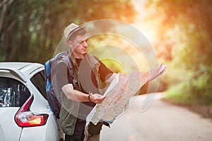 Young man backpacker travelling and photographer with car