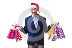 The young man with bags after christmas shopping on white background