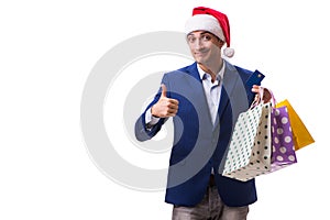 The young man with bags after christmas shopping on white background