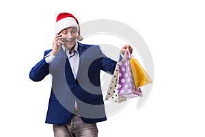 The young man with bags after christmas shopping on white background