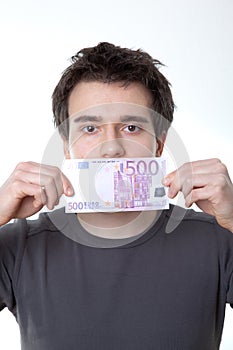 Young man with a banknote on his mouth