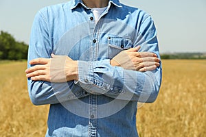 Young man in barley field. Agriculture business