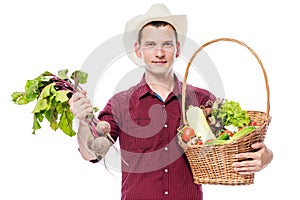 Young man with a basket of vegetables from the garden