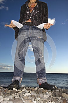 Young Man at Beach with Empty Pockets