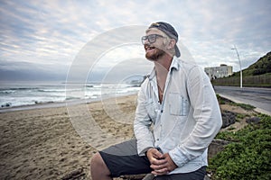 Young man on beach smiling