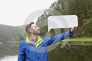 Young man with beard in jacket says any words with possibility of writing them on white rectangular background