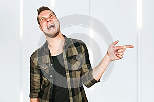 Young man with beard taunts and shows finger, point hand