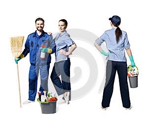 A young man with a beard and in uniform is smiling and holding a broom and spray, next to the girls in uniform, the ode is turned