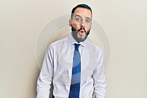 Young man with beard wearing business tie afraid and shocked with surprise expression, fear and excited face