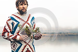 Young Man bearded with fir tree branch Fashion Travel Lifestyle