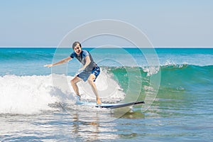 Young man, beginner Surfer learns to surf on a sea foam on the B