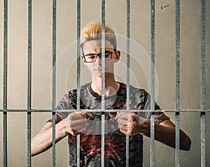 Young man behind bars