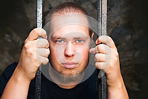 Young man behind the bars