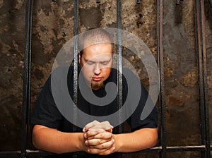 Young man behind the bars