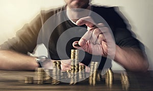 Man rising coins on stacks