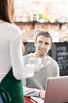 Young man being served at cafe