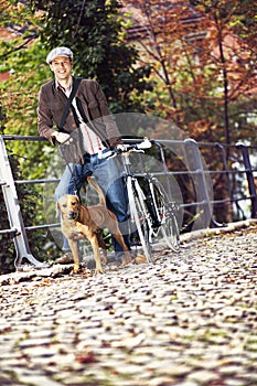 Young man with bicycle and dog