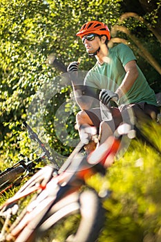 Young man biking on a mountain bike - taking a break