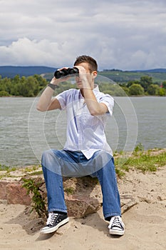 Young man with binoculars