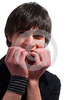 Young man is biting his nails