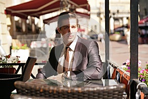 Young man in black business suit, white shirt and tie