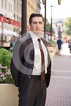 Young man in black business suit, white shirt and tie