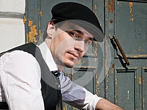 Young man in black cap in vintage style