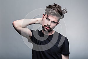 Young man in black doubting